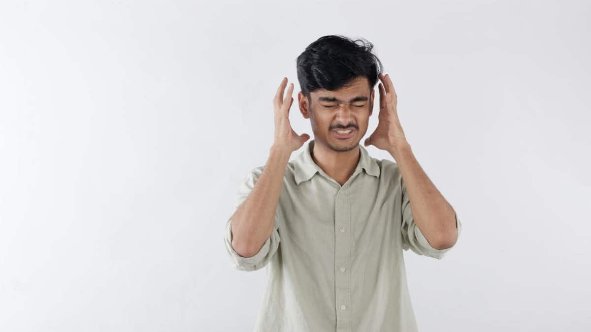 Portrait of an Indian Asian man showing stress and anger. Concept representing frustration, mental pressure, anxiety, and emotional struggle.