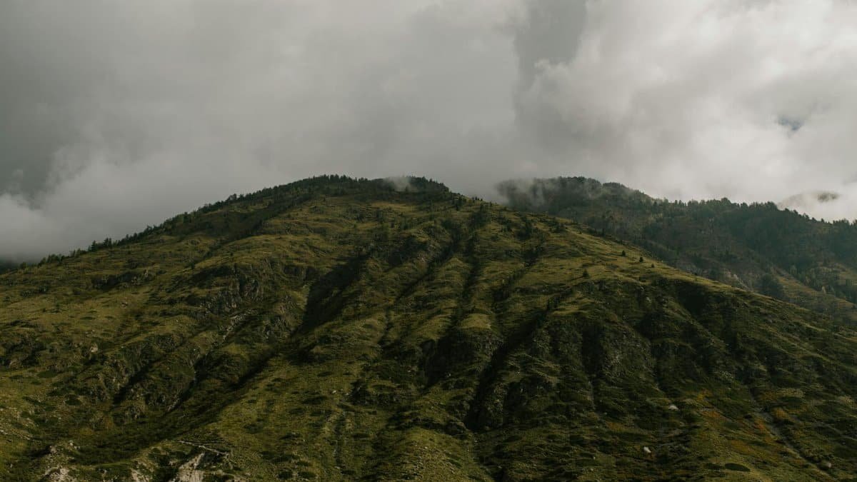 Cloud-covered mountain scene creates a moody and natural landscape.