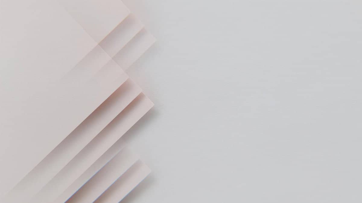 A minimalistic abstract composition featuring layered sheets on a gray surface, perfect for modern design.