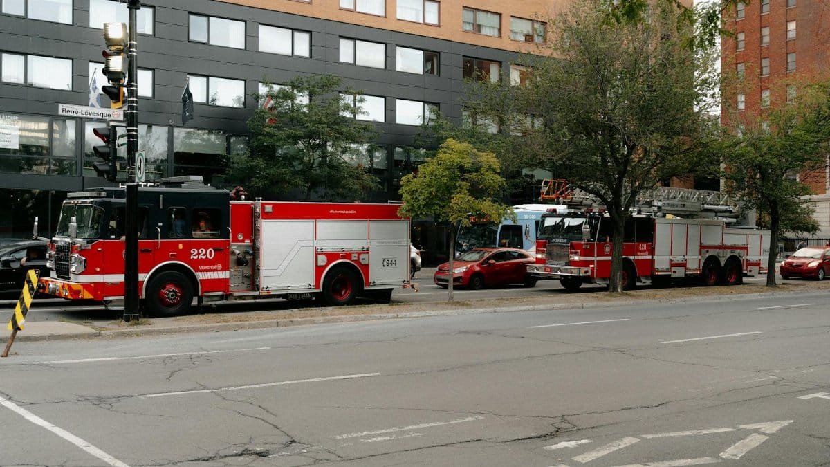 Fire trucks with emergency lights on in downtown Montreal, René-Lévesque Boulevard, Quebec.