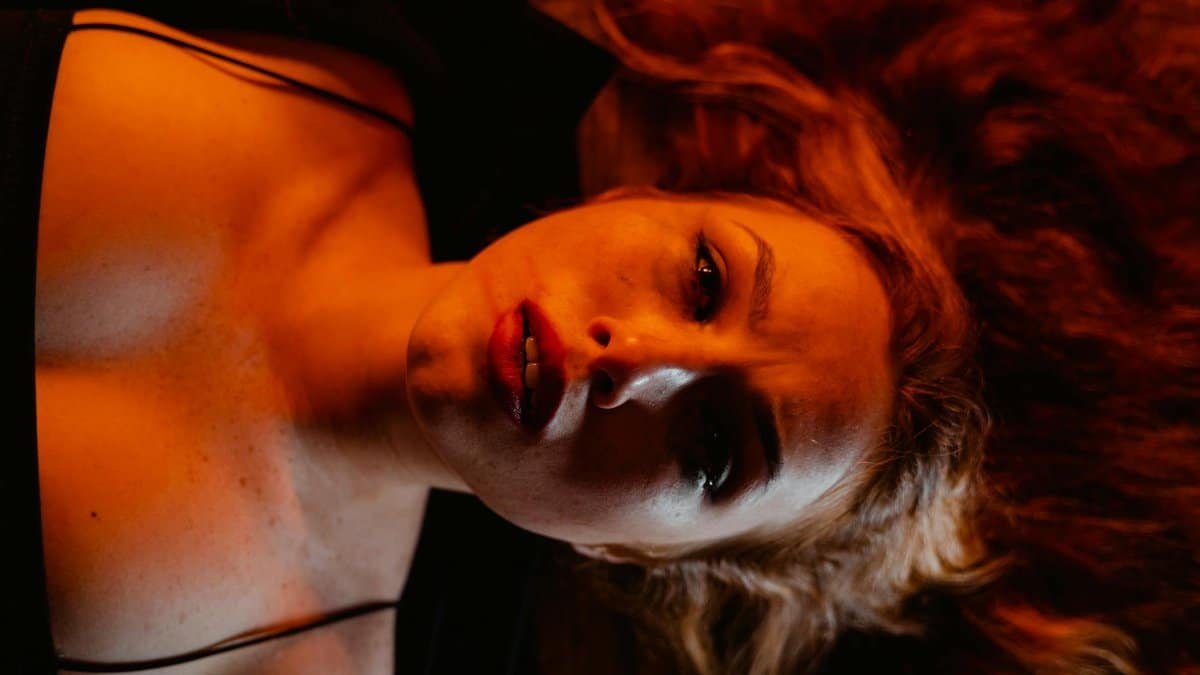 Close-up emotional portrait of a woman lying down, conveying deep feelings.