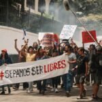 Demonstrators holding banners and signs during a peaceful protest in San José, Costa Rica.