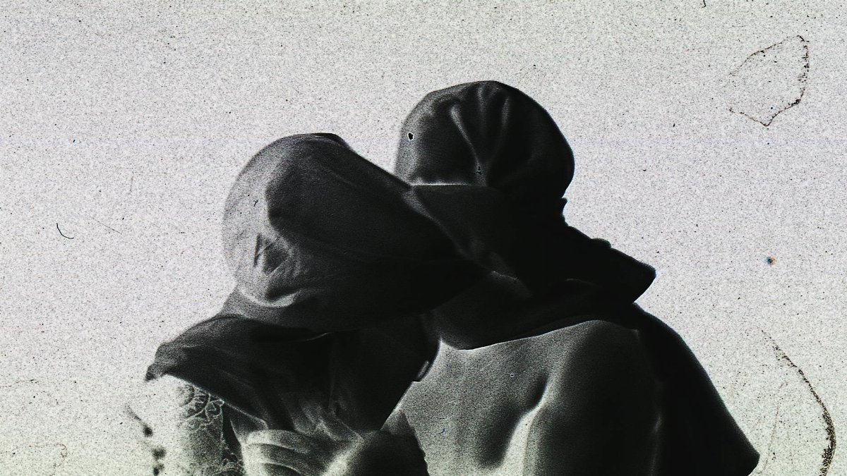 Abstract negative art of two people in an embrace, creating a mysterious atmosphere.