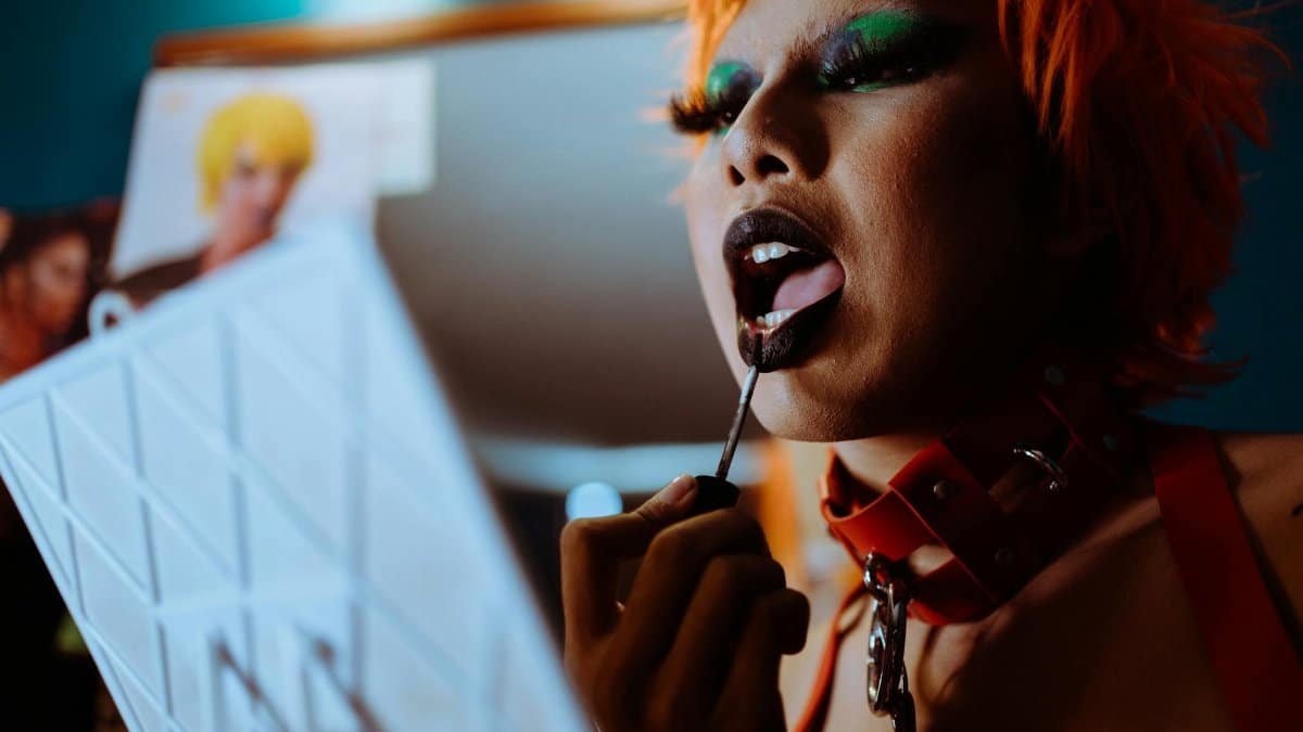 A bold and edgy fashion statement with striking makeup and vibrant style.