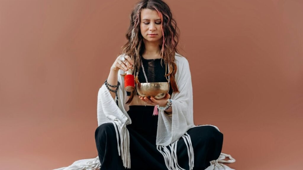 A serene woman meditates with a singing bowl, evoking a sense of peace and balance.