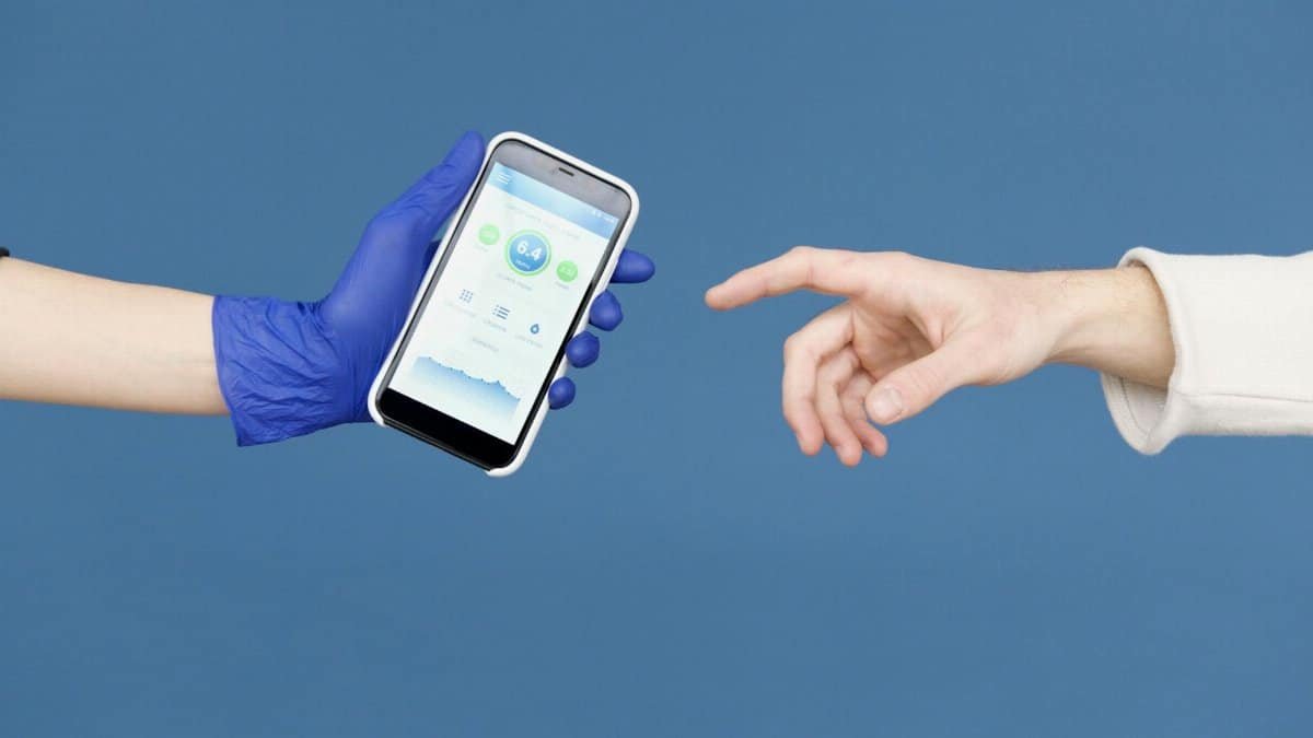Conceptual image of hands reaching for smartphone with health app on blue background.