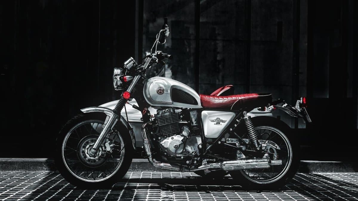 A classic vintage motorbike in good condition, captured in a dramatic urban setting.