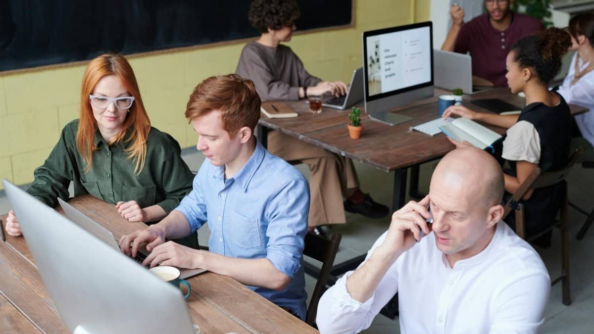 A busy team of professionals collaborating in a modern office space during the day.