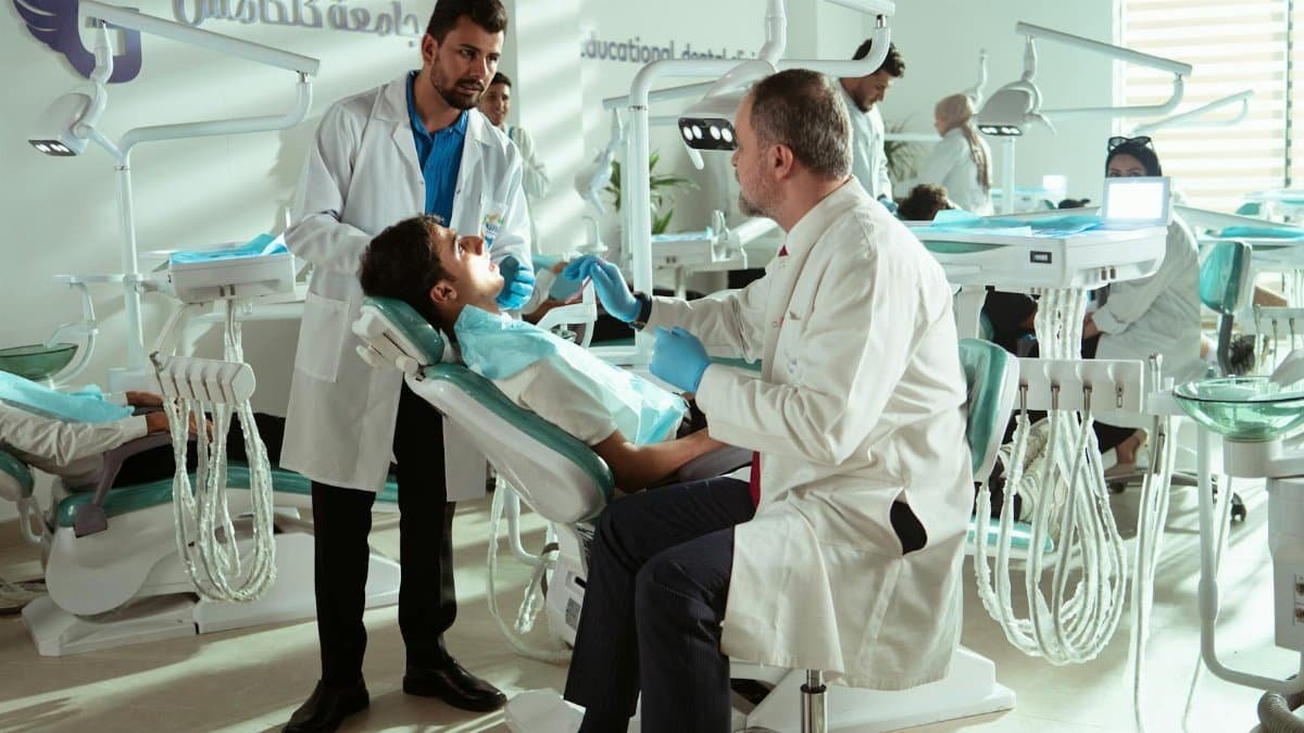 Dentists and patients in a bustling Baghdad dental clinic, showcasing healthcare professionalism.