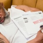 Sleeping man with financial documents, symbolizing stress and bankruptcy.