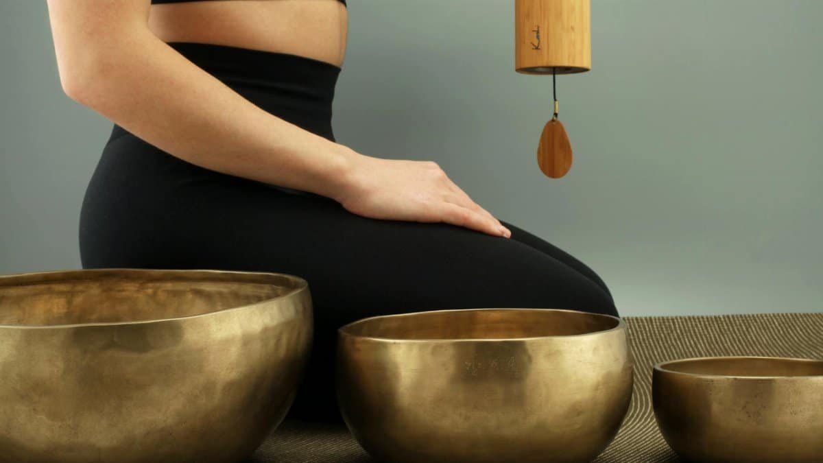 A tranquil scene featuring meditation with Tibetan singing bowls for relaxation and healing.
