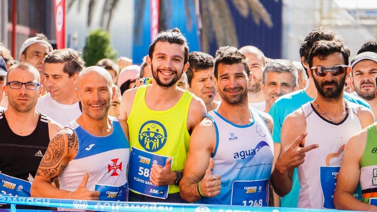 Smiling and determined runners gather at the starting line of a race.