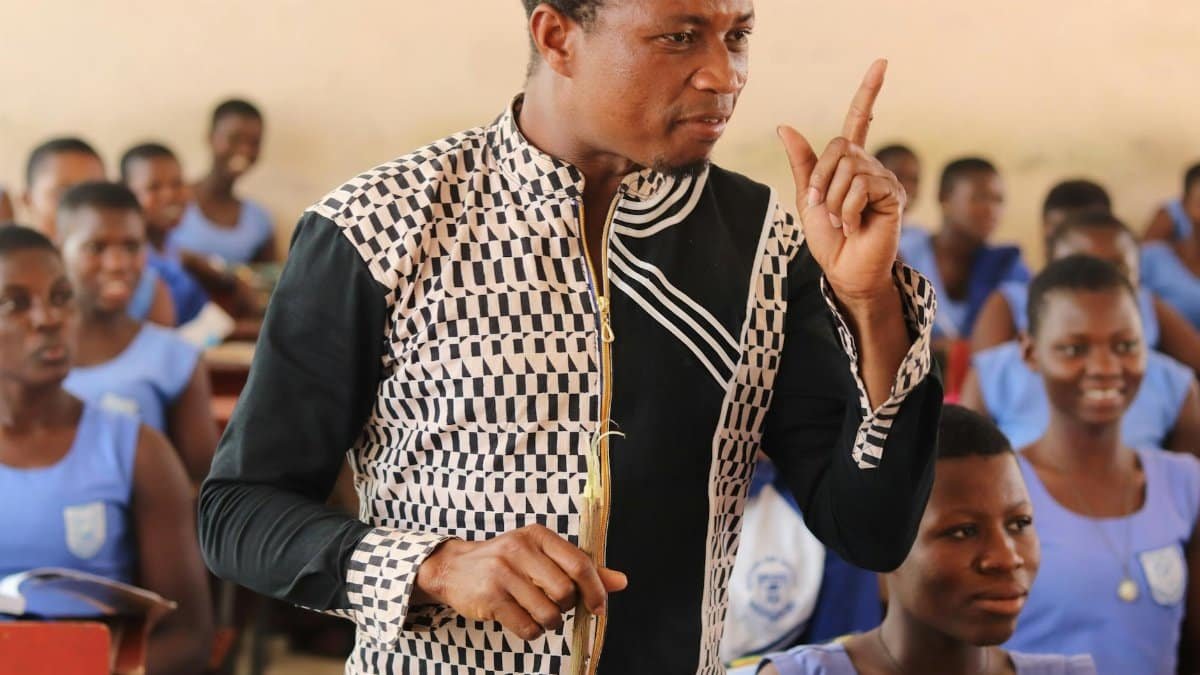 Engaging teacher in a vibrant classroom setting in Ghana. Inspiring education.