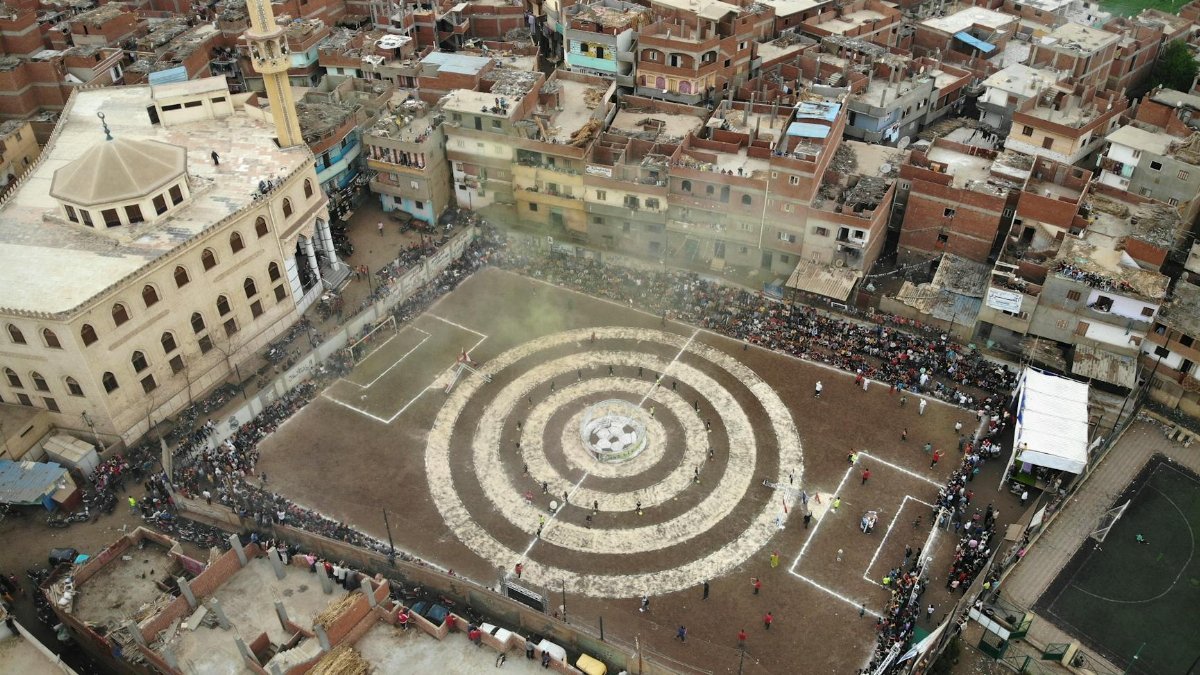 Aerial shot of a lively sports event in Qashtoukh, Egypt, with community engagement.