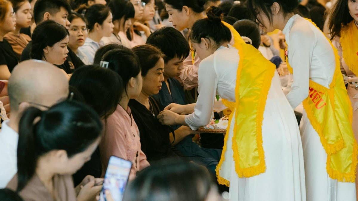 A vibrant cultural ceremony with participants engaging in traditional practices indoors.