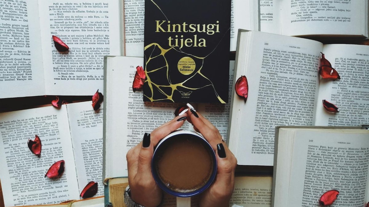 A serene scene featuring a book, cup of coffee, and scattered rose petals, perfect for relaxation themes.