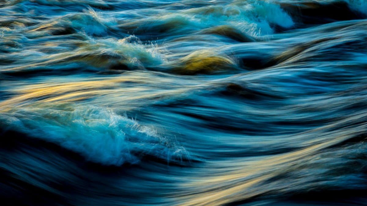 Capture of flowing ocean waves in motion, showcasing the vibrant colors and dynamic movement of water.