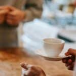 Two people enjoying a coffee moment in an inviting home kitchen setting.