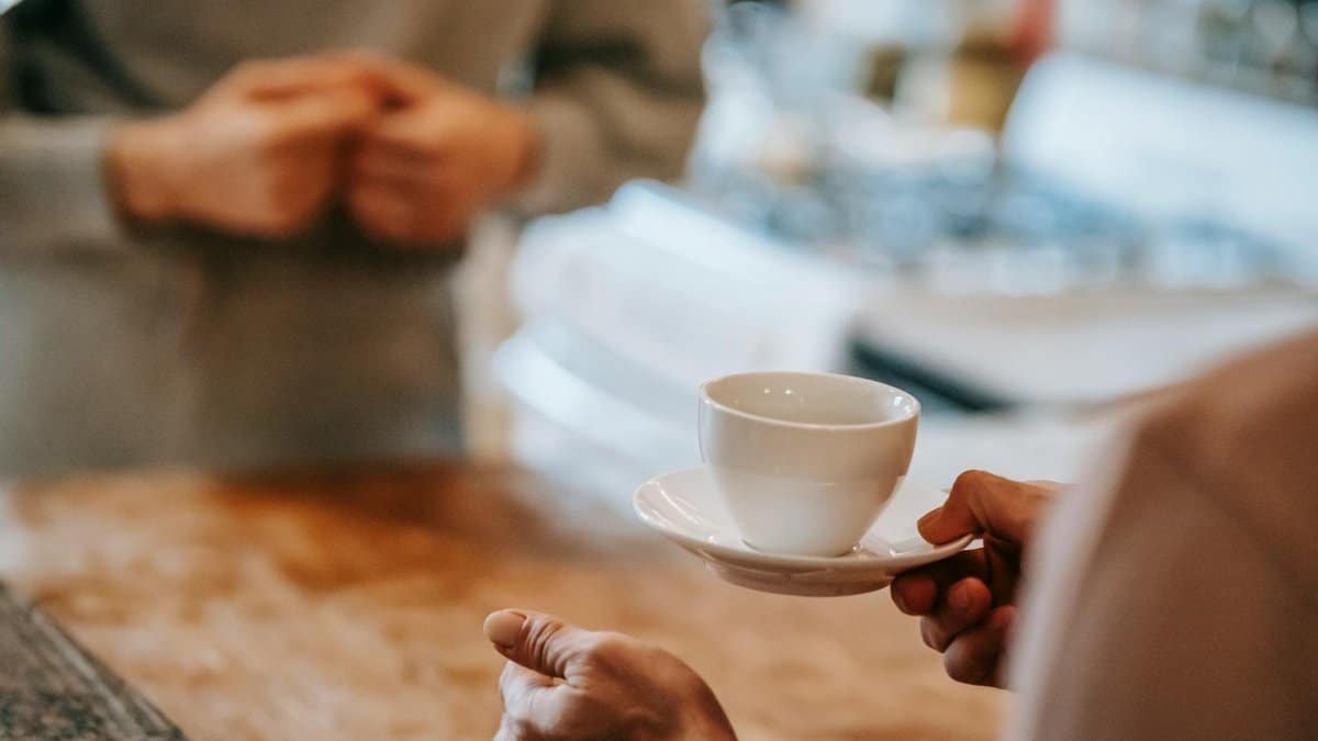 Two people enjoying a coffee moment in an inviting home kitchen setting.