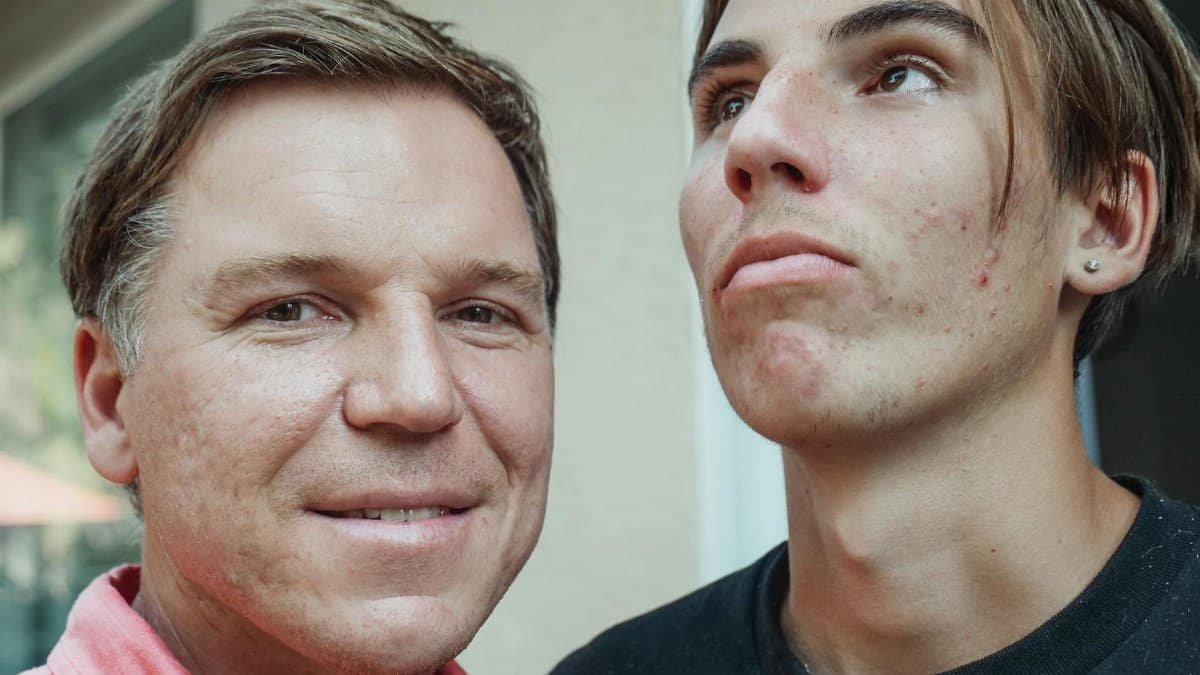 Close-up of father and teenage son posing together, showcasing family resemblance and natural expressions.
