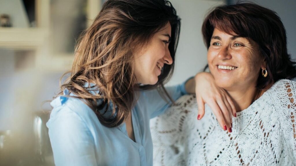 Happy mother and daughter enjoying time together indoors, capturing love and connection.