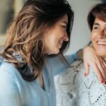 Happy mother and daughter enjoying time together indoors, capturing love and connection.