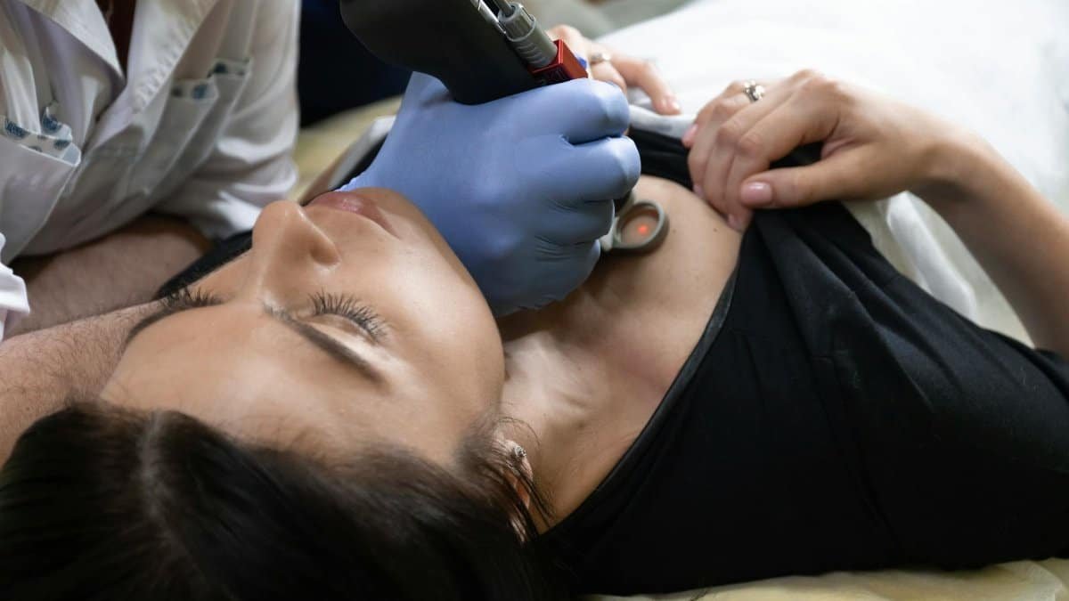 Close-up of a woman receiving dermatological treatment in a clinical setting.