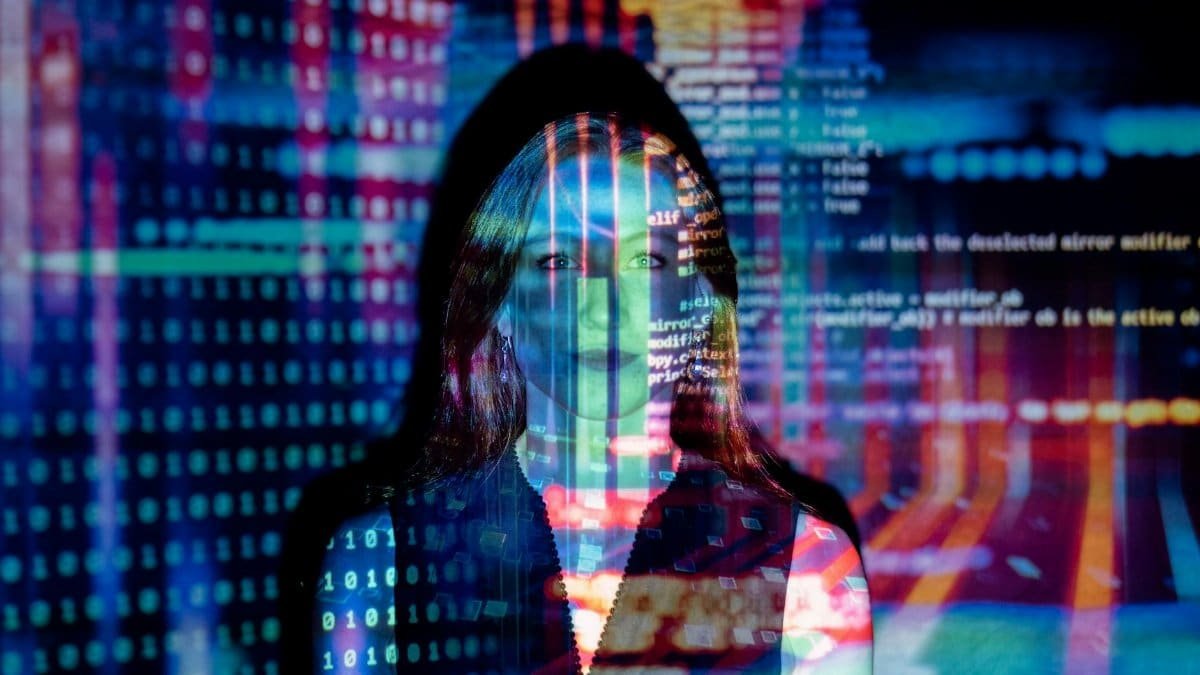 A woman with digital code projections on her face, representing technology and future concepts.