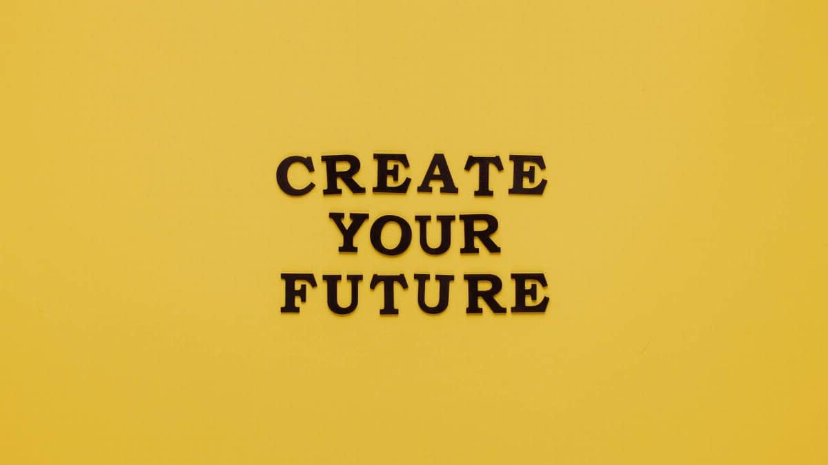 Bold text 'CREATE YOUR FUTURE' on minimalist yellow background. Inspiring design.