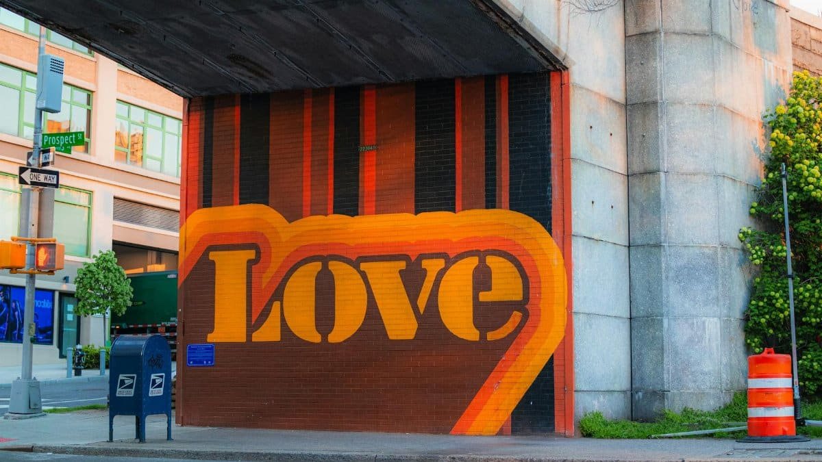 Colorful graffiti mural in a city setting with a bold 'Love' message.