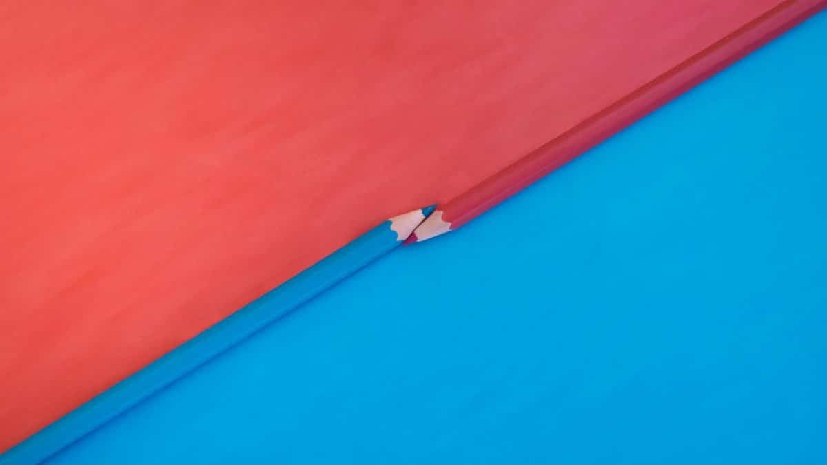 Abstract composition featuring red and blue pencils on contrasting red and blue backgrounds.