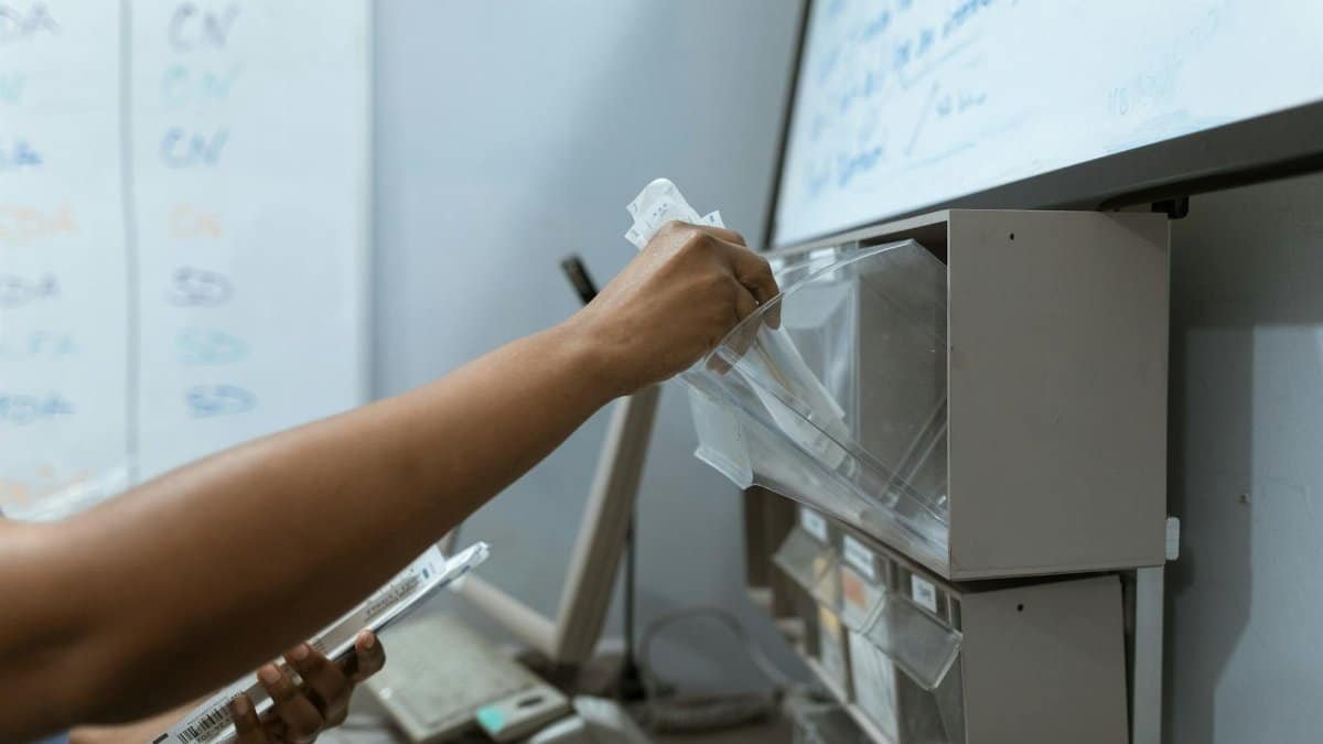 A healthcare worker organizing syringes in a clinic setting, demonstrating medical precision.