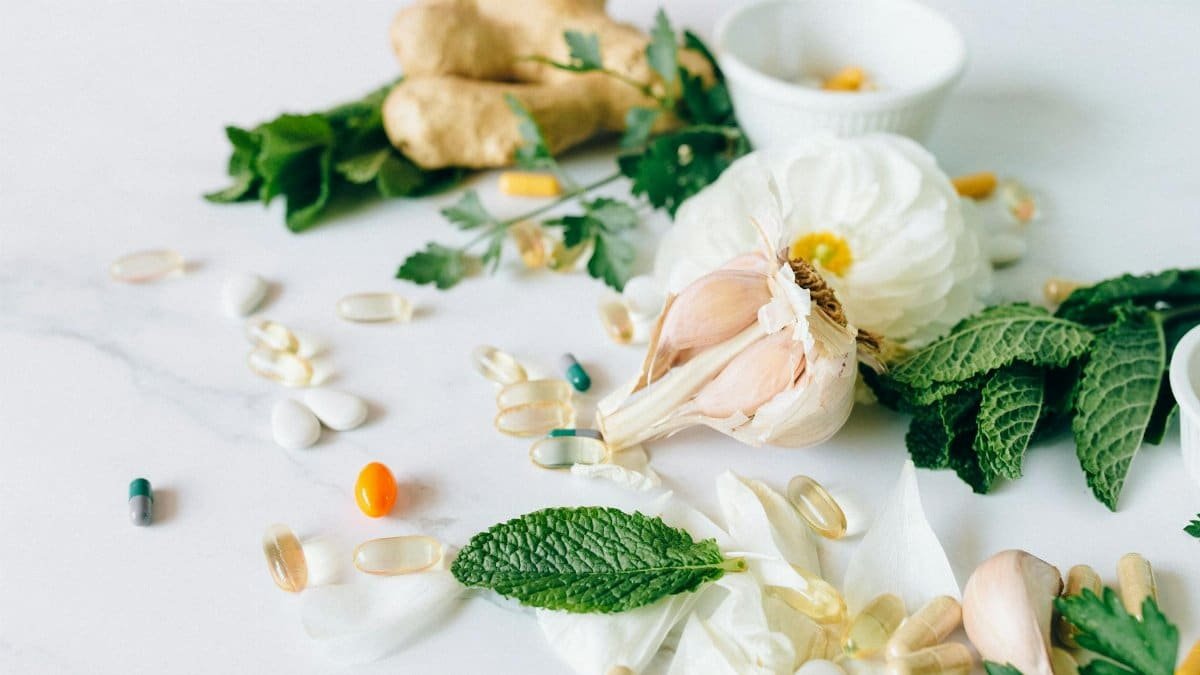 A flat lay of various herbal remedies and vitamin supplements, featuring natural herbs and capsules.