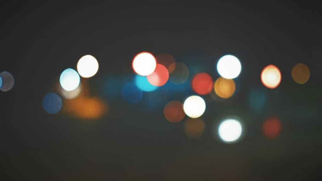 An artistic bokeh effect of colorful city lights creating a soft, dreamy atmosphere.