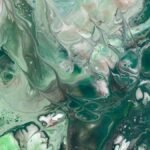 A mesmerizing abstract fluid art piece with swirling green and blue patterns creating a calm and dynamic visual.