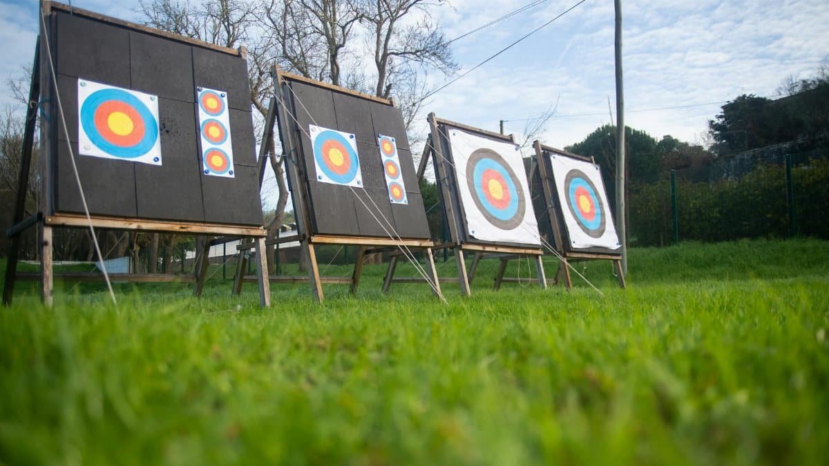 Archery targets on a lush green field outdoors, set for practice in Portugal.