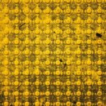 Close-up of a textured yellow tactile ground surface highlighting geometric patterns in Boise, Idaho.