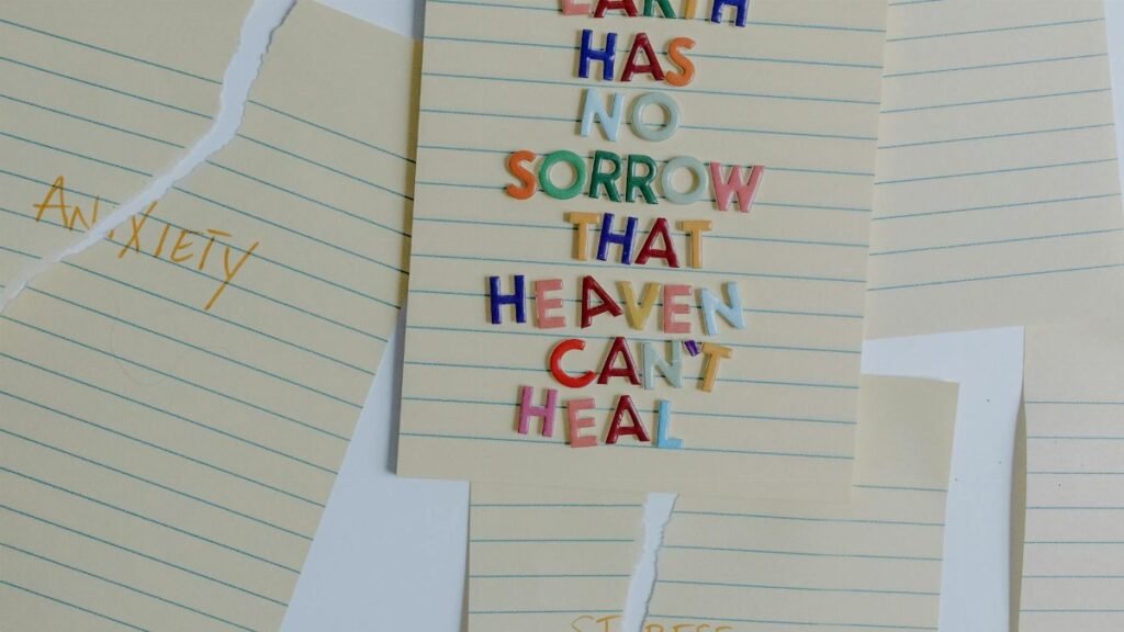 Torn papers with an uplifting quote emphasizing healing and overcoming anxiety and stress.