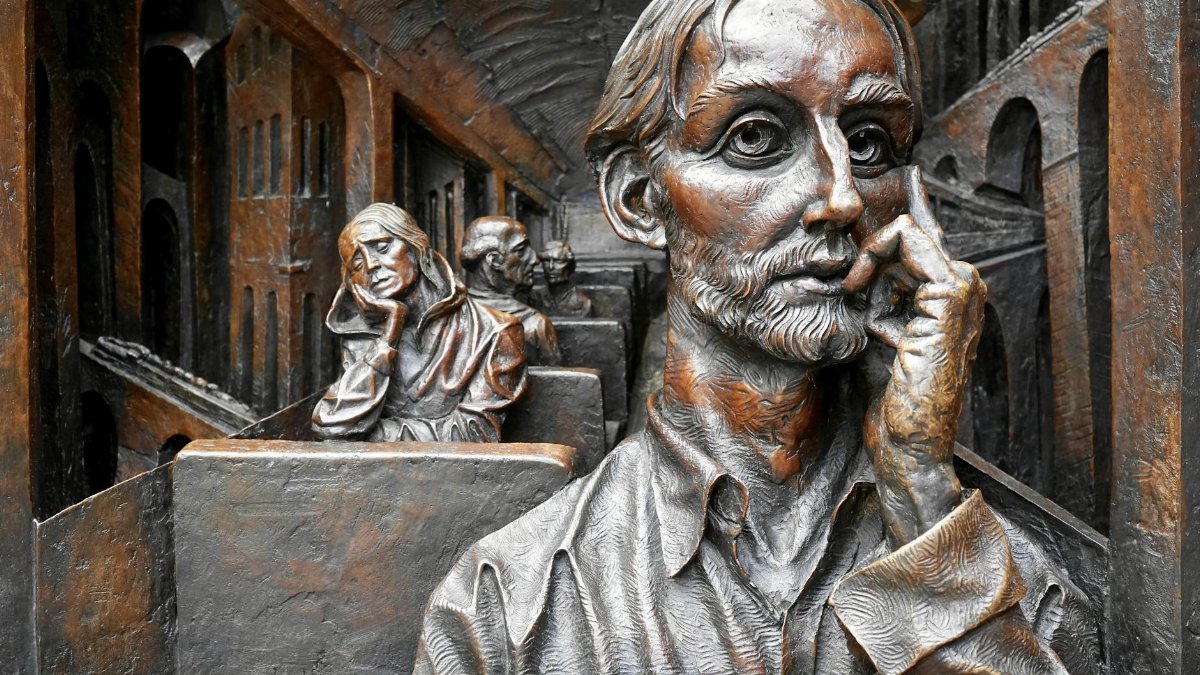 Detailed bronze artwork depicting thoughtful figures on a train. Captures introspection and artistry.