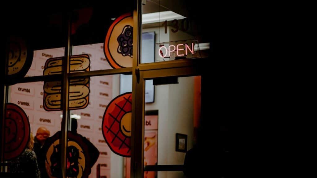 Night view of a cookie shop with neon sign in Colorado Springs.