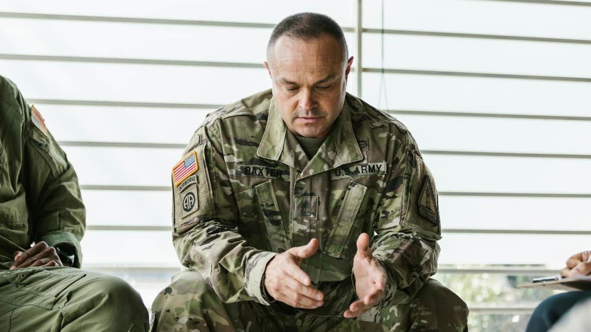 Military personnel engaging in a group therapy session focusing on mental health support.