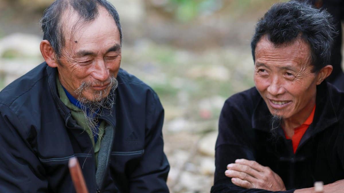 Close-up of two elderly men from the Hmong community in Lào Cai, Vietnam, showcasing traditional life.