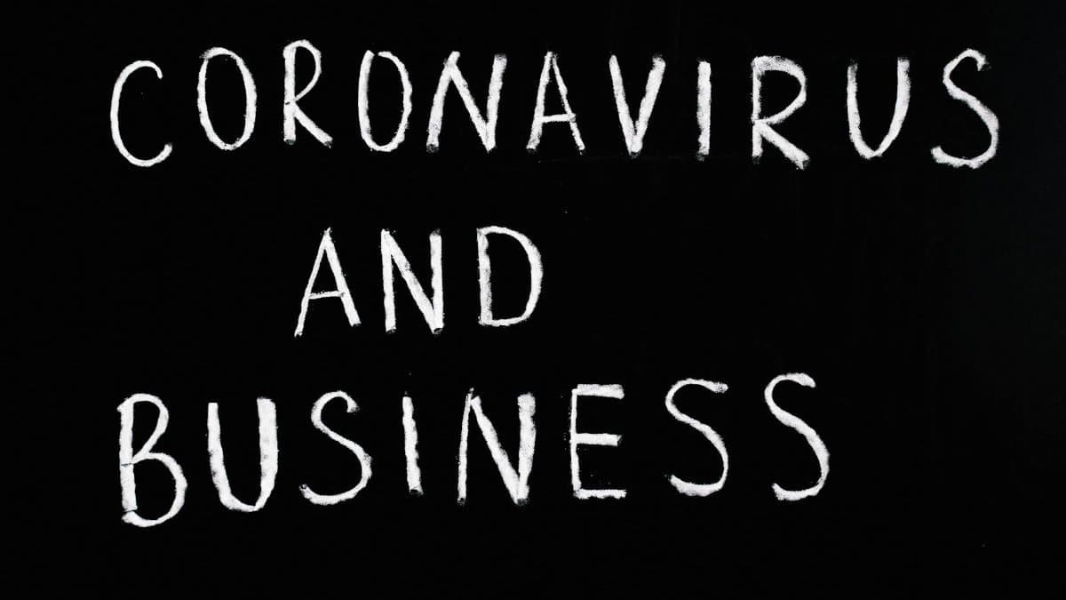 Chalkboard with 'Coronavirus and Business' written on it, illustrating COVID-19 impact.