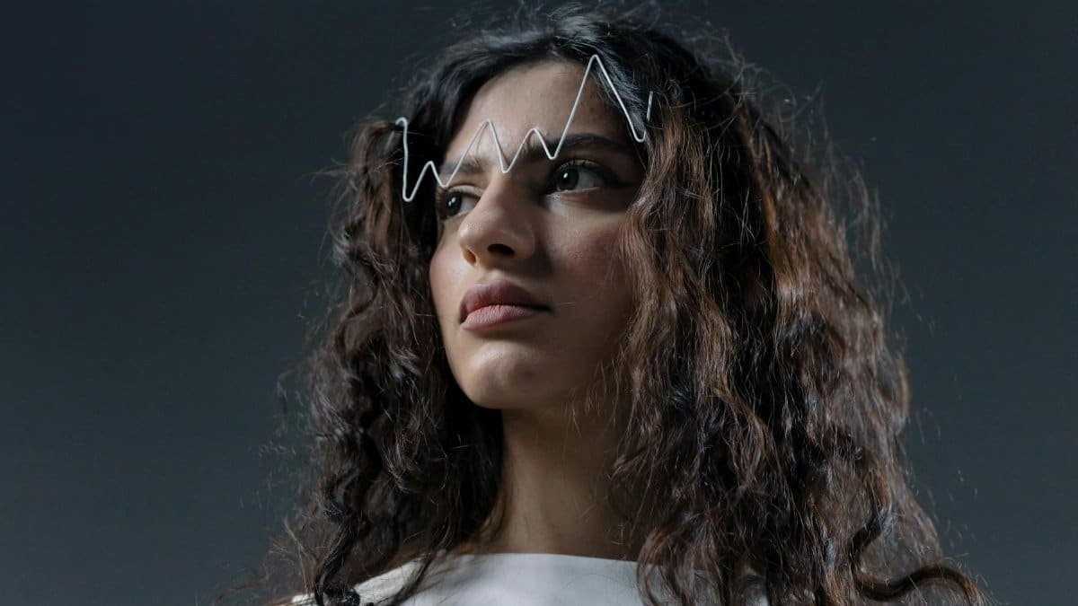 Artistic shot of a woman with a unique hair accessory, capturing emotion.