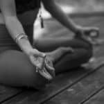 A person practicing yoga in outdoor setting, focusing on meditation and mindfulness.