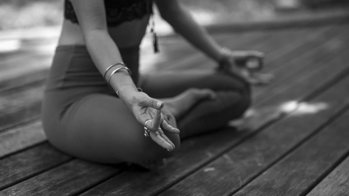 A person practicing yoga in outdoor setting, focusing on meditation and mindfulness.