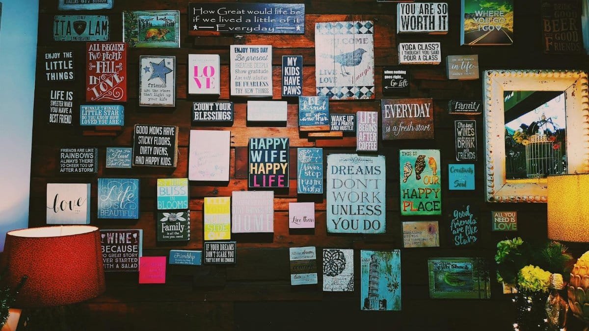 A warm and inviting indoor space with motivational quotes displayed on a wooden wall.