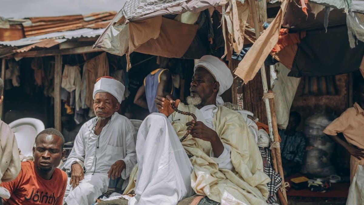 Candid photo of men in a traditional market, depicting cultural attire and daily life.