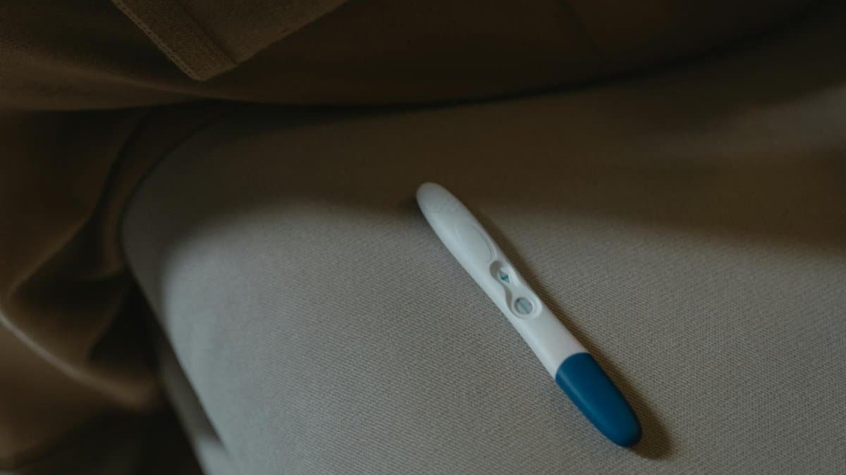 A close-up image of a pregnancy test resting on a soft fabric surface, symbolizing anticipation and new beginnings.