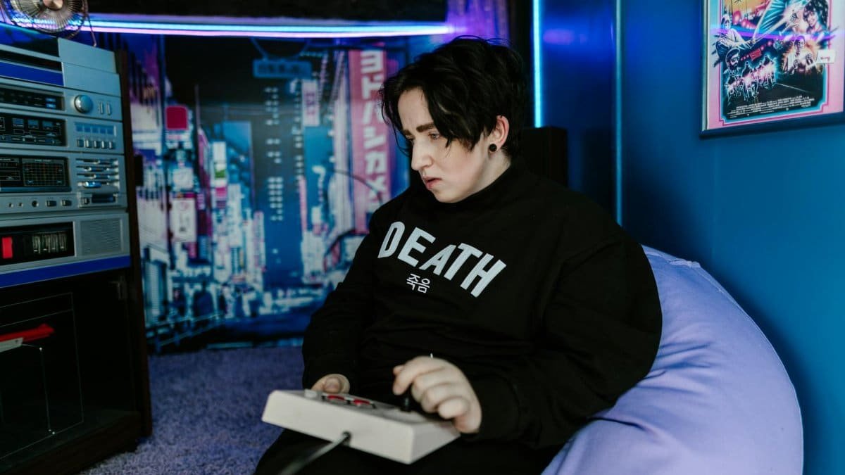 A person plays a game with retro elements in a vibrant room. Perfect for vintage and gaming themes.